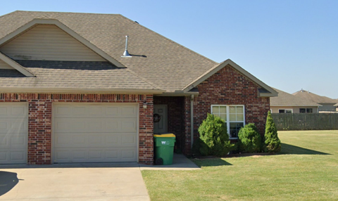 A house with a garage door and a window.