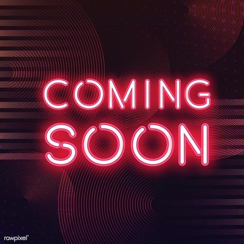 A neon sign that says "COMING SOON" in bright pink.