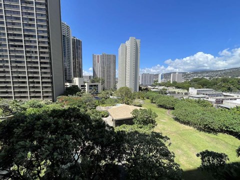 A view of a cityscape with tall buildings and a clear blue sky.