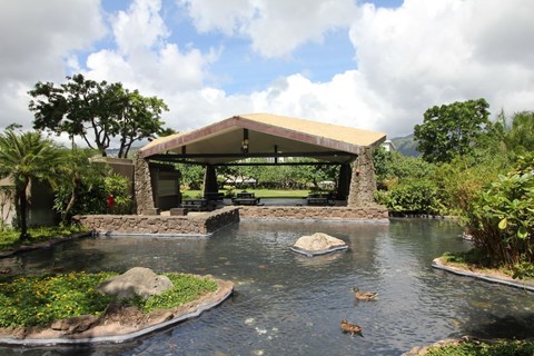 A pond with a gazebo in the middle of it.