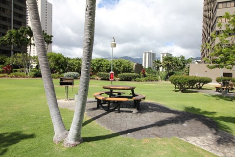 A picnic table is surrounded by trees in a park.