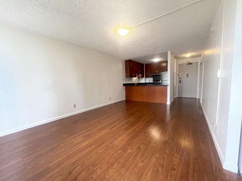 A room with wooden flooring and white walls.