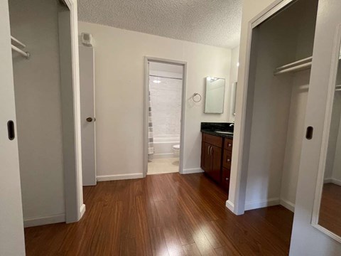 A room with wooden floors and white walls.
