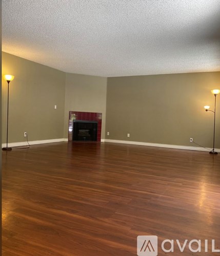 A room with wooden floors and a fireplace.