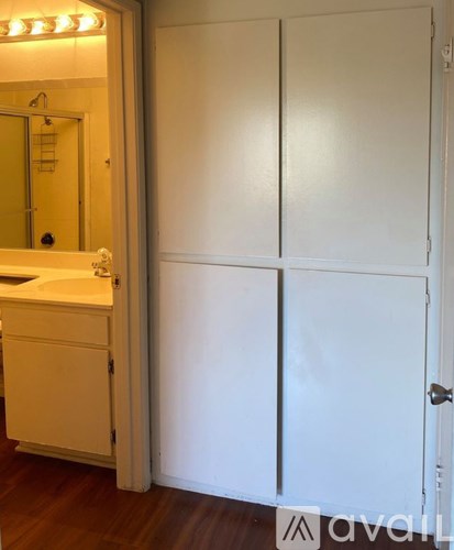 A white bathroom with a sink and a mirror.