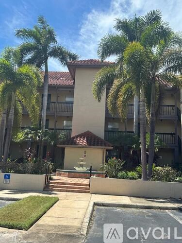 A building with a palm tree in front of it.