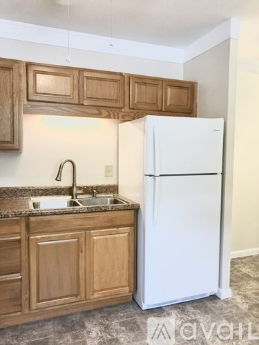 A hallway with a door at the end and a counter on the right.