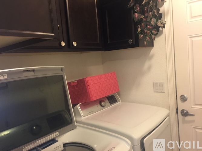 A washing machine is in a small laundry room.