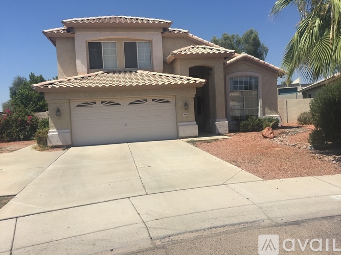 A house with a tiled roof and a garage door.