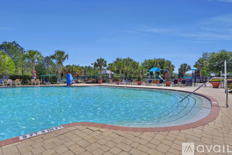 A large outdoor swimming pool surrounded by a brick border.