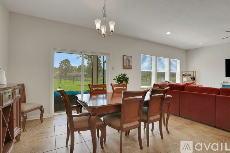 A dining room with a wooden table and chairs.