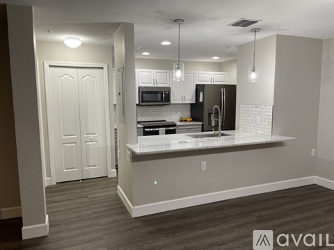 A kitchen with a white countertop and a refrigerator.