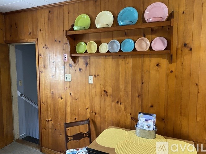 A wooden shelf with plates on it.
