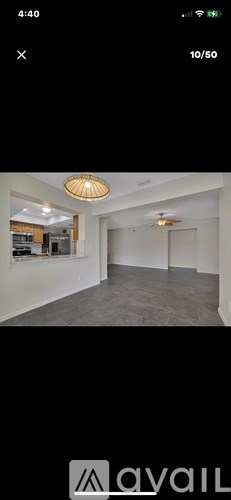 A room with a ceiling light and a fan.