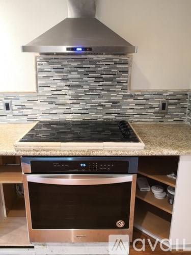 A modern kitchen with a stainless steel oven and microwave.