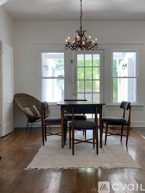 A dining room with a wooden table and chairs.
