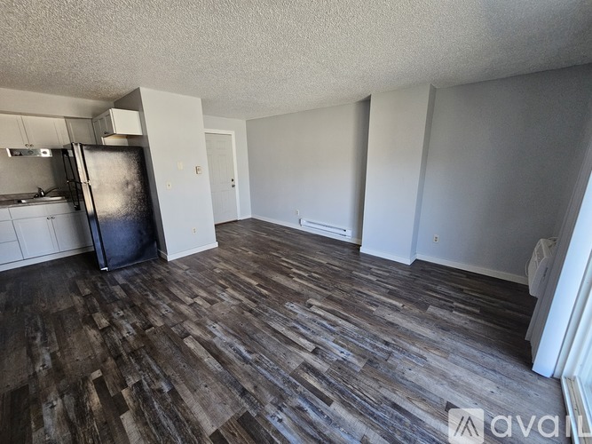 A kitchen with wooden cabinets and a black stove top oven.