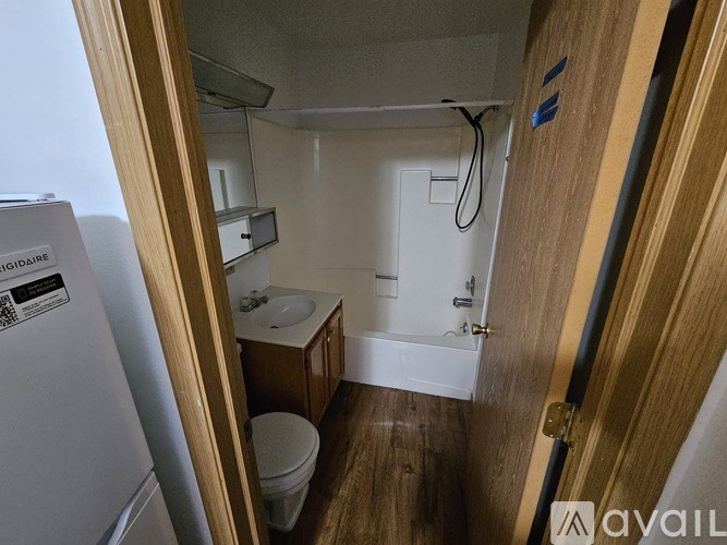 A small bathroom with a toilet, sink, and mirror.