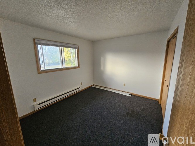 A room with a window and a door.