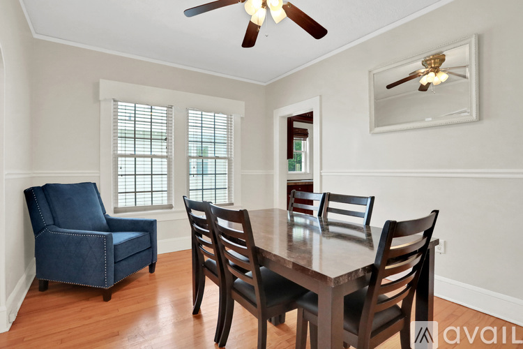 A dining room with a wooden table and chairs.