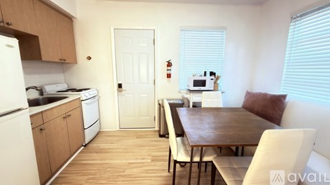 A kitchen with a table and chairs in the middle of the room.