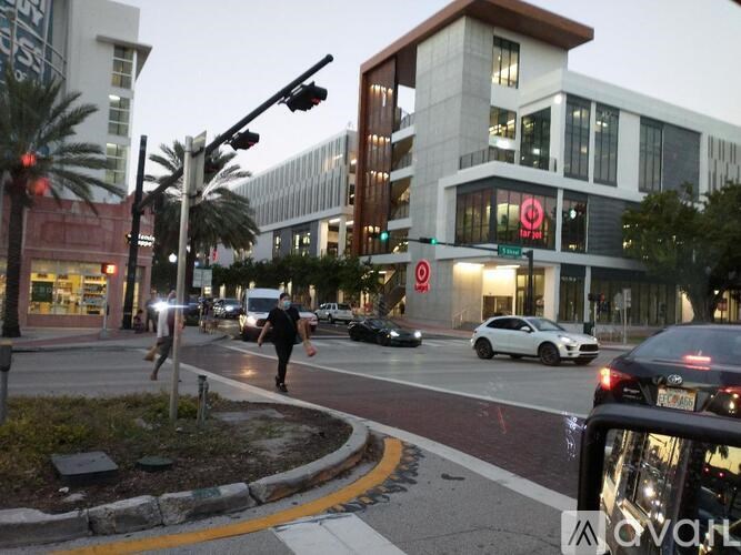 A man is crossing the street at a crosswalk.