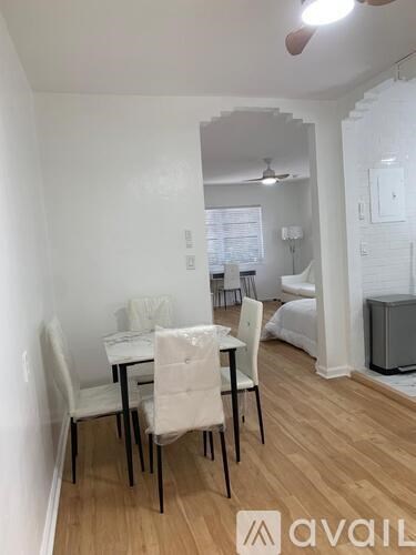A dining room with a table and chairs.