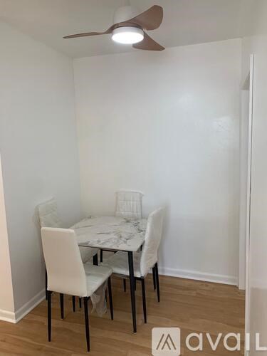 A small dining room with a table and chairs.