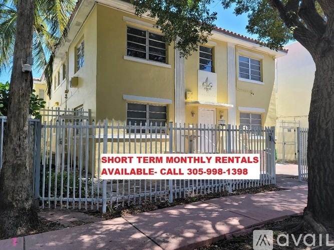 A sign in front of a building advertises short term monthly rentals.