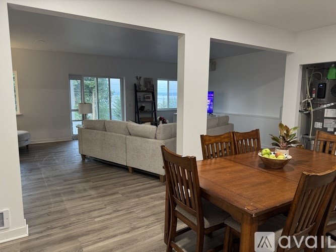A dining room with a wooden table and chairs.