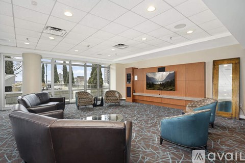 A living room with a brown couch and blue chair.