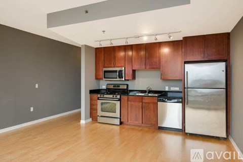 A kitchen with wooden cabinets and stainless steel appliances.