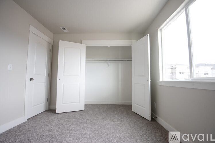 A room with a carpeted floor and white walls.