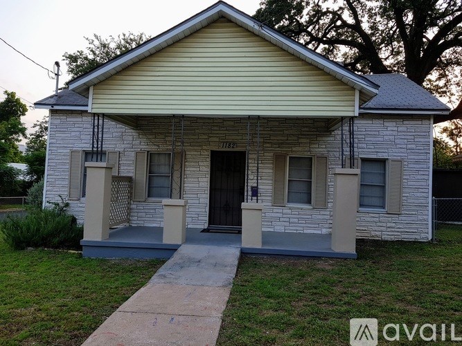 A small house with a porch and a front door.