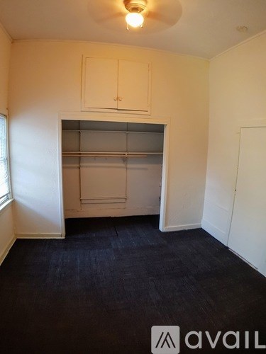 A room with a pantry and a window.