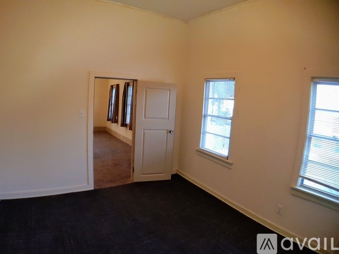 A room with a door, a window, and a wall.