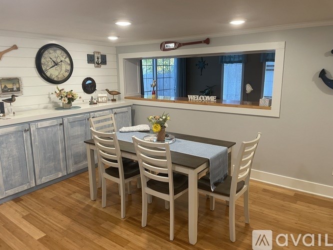 A dining room with a wooden table and chairs.