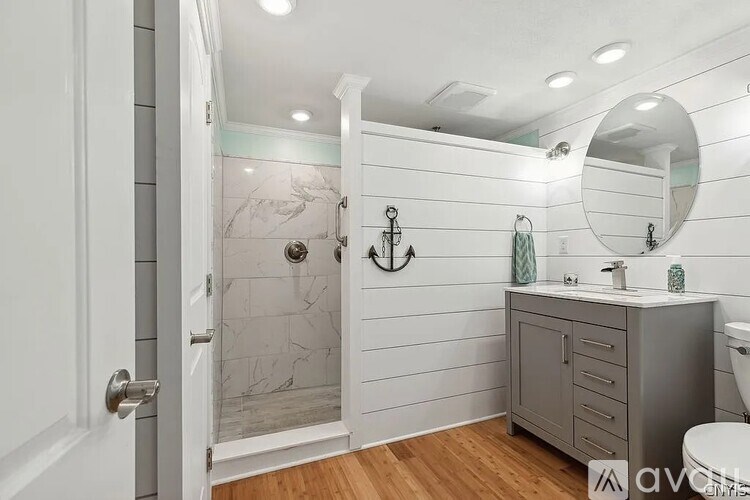 A bathroom with a walk-in shower and a toilet.