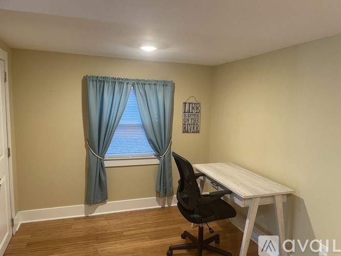 A room with a desk and a chair.