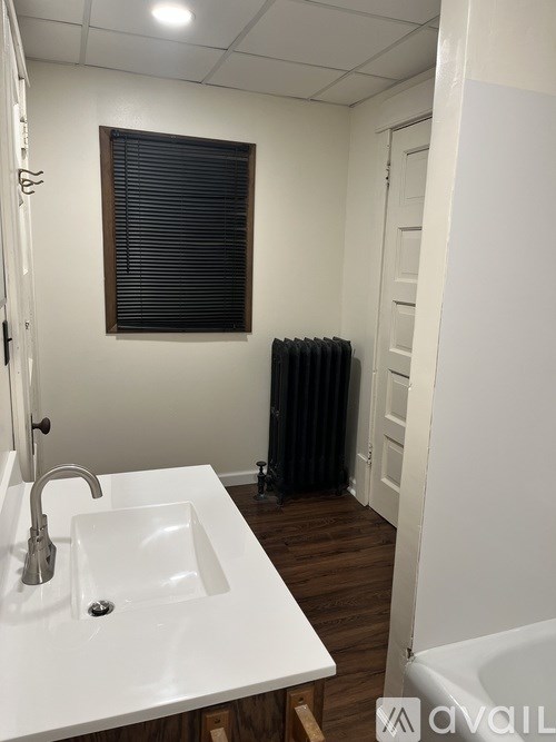 A white sink with a silver faucet in a bathroom.