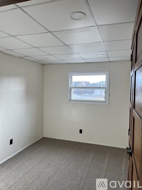 A room with a window and a door.