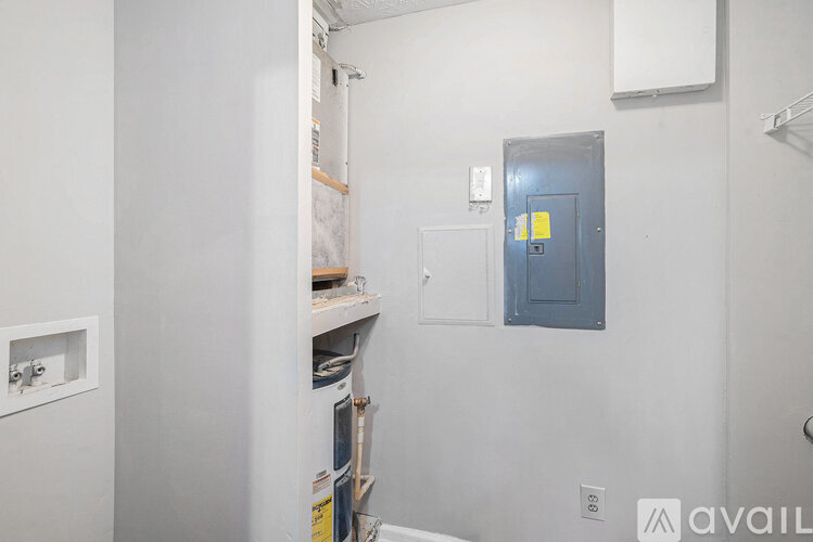 A room with a door and a shelf with some items on it.