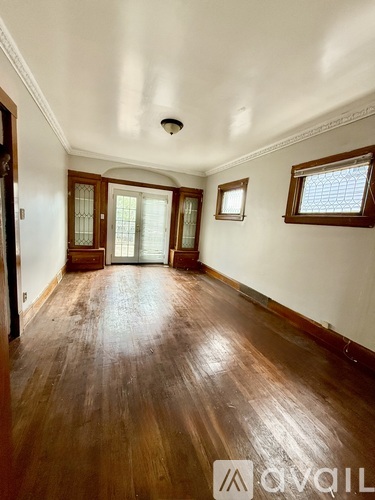 A room with wooden floors and white walls.