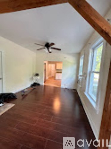 A room with a ceiling fan and tile flooring.