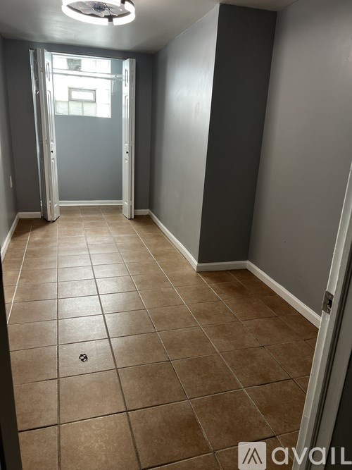 A room with tiled flooring and a ceiling fan.