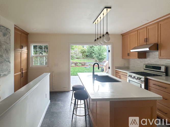 A kitchen with wooden cabinets and a white countertop.