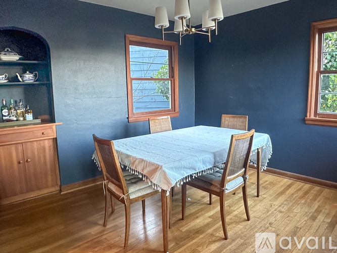 A dining room with a table and chairs.