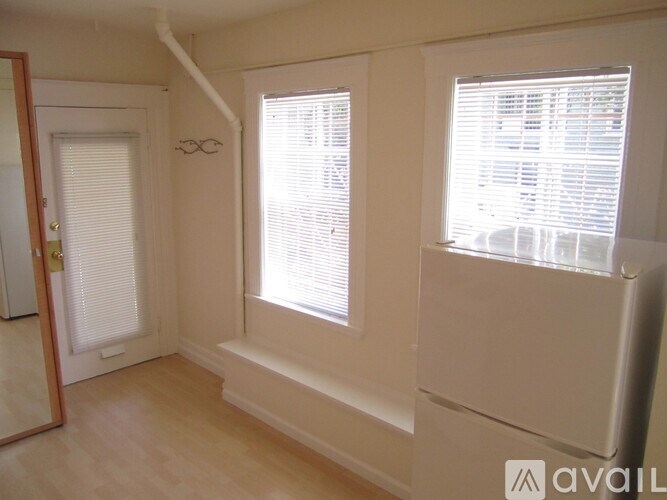 A room with a window and a door.