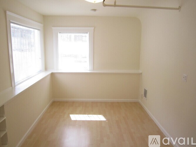 A room with wooden flooring and a window.