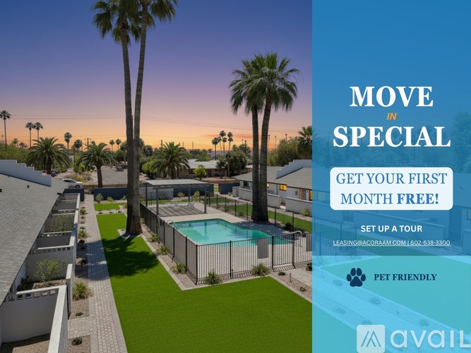 A pool surrounded by a fence and palm trees with a sign offering a free first month.